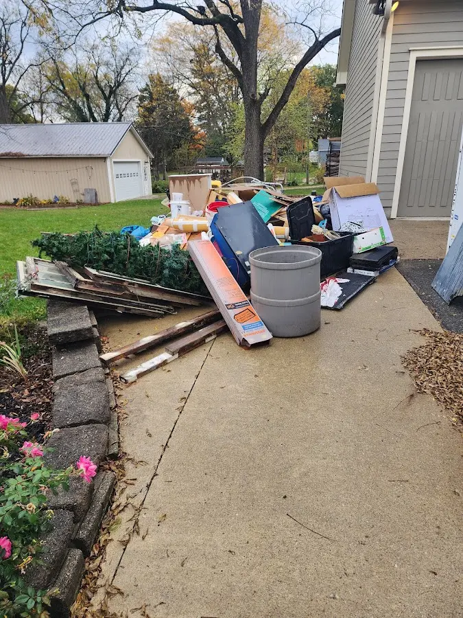 Dumpster being loaded with debris for Estate Cleanout Dumpster Rental in Ecorse